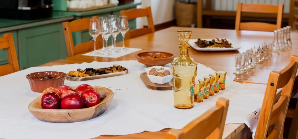 Table with local delicacies and spirits prepared for tasting.