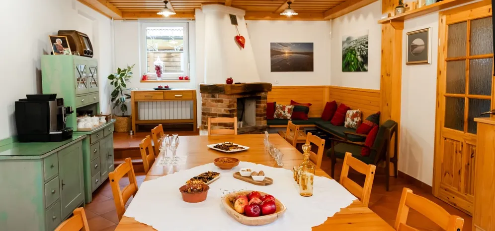 Spirits tasting room with a large wooden table and fireplace.