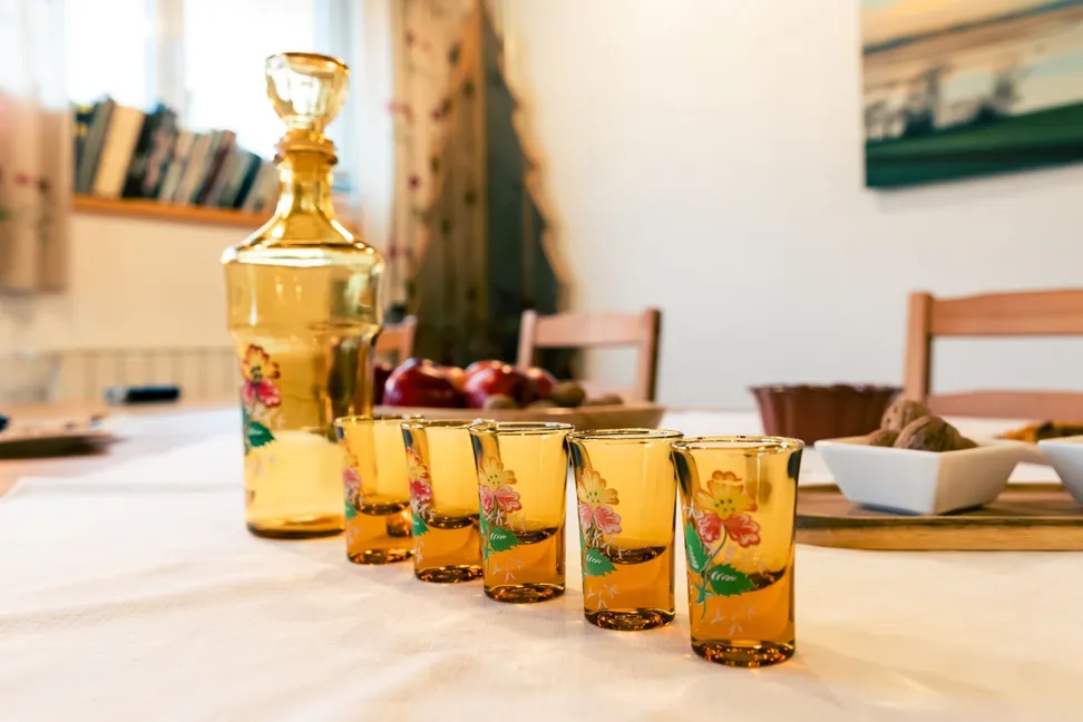 Decorated glasses and a bottle of spirits prepared for tasting.