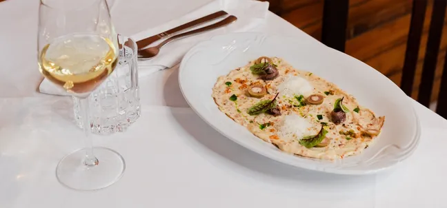 Cold starter served with a glass of white wine at Pri Stani restaurant.