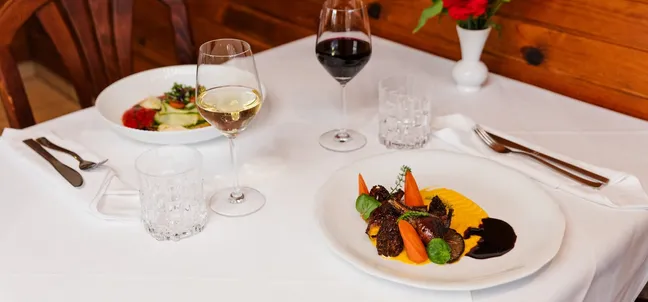 Dishes from the meat and vegetarian menus on a set table at Pri Stani restaurant.