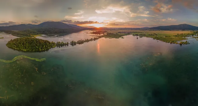 Panoramic photo of Lake Cerknica from the direction of Javorniki mountains at sunrise.